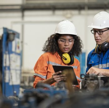 Productivity Improvement of Welding Assembly Lines in Manufacturing Industry. Manufacturing Process Engineers having discussion on welding jig design data to improve and reduce defect loss of work piece in welding process.